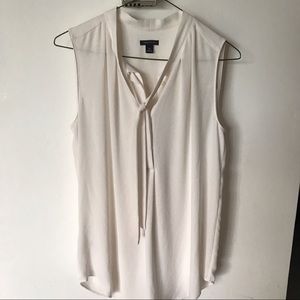Sleeveless white blouse with ribbon